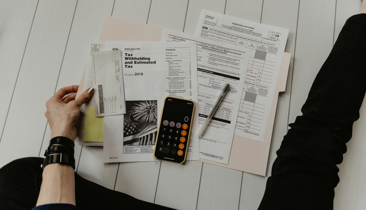 Two people reviewing printed financial statements at a table